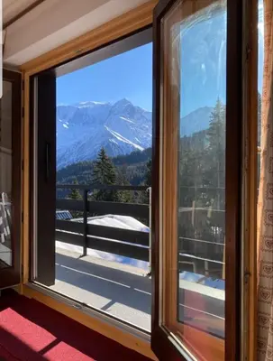a window with a view of a mountain at Appartement Saint Gervais les Bains piscine et vue imprenable Mont Blanc in Saint-Gervais-les-Bains