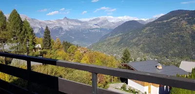 a view from a balcony of a valley with mountains at Appartement Saint Gervais les Bains piscine et vue imprenable Mont Blanc in Saint-Gervais-les-Bains