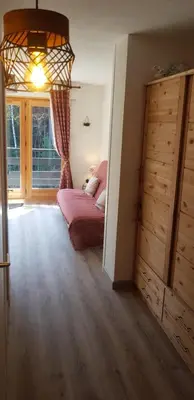 a bedroom with a bed and a large window at Appartement Saint Gervais les Bains piscine et vue imprenable Mont Blanc in Saint-Gervais-les-Bains