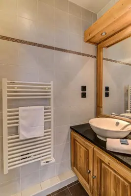 a bathroom with a sink and a mirror at APARTMENT LE PARADIS 2 - ALPES TRAVEL - CENTRAL CHAMONIX (sleeps4-5) in Chamonix-Mont-Blanc