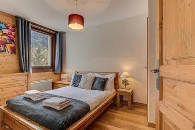 a bedroom with a bed with towels on it at APARTMENT LE PARADIS 2 - ALPES TRAVEL - CENTRAL CHAMONIX (sleeps4-5) in Chamonix-Mont-Blanc