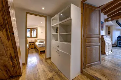 a room with a closet with a door and a bedroom at Tiki Lodge - hot tub & sauna in Chamonix-Mont-Blanc