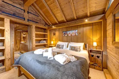 a bedroom with a large bed in a cabin at Tiki Lodge - hot tub & sauna in Chamonix-Mont-Blanc