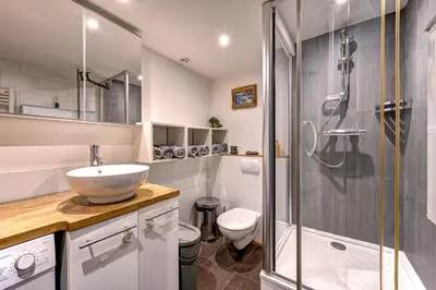 a bathroom with a sink and a shower and a toilet at Tiki Lodge - hot tub & sauna in Chamonix-Mont-Blanc