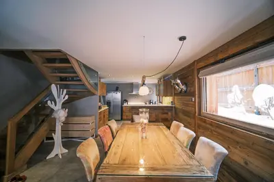 a dining room with a wooden table and chairs at chalet Polar in Chamonix-Mont-Blanc