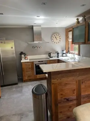 a kitchen with a counter and a clock on the wall at chalet Polar in Chamonix-Mont-Blanc