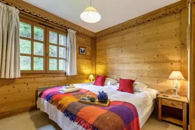 a bedroom with a bed with towels on it at Chalets d'Henri 67 - Happy Rentals in Chamonix-Mont-Blanc