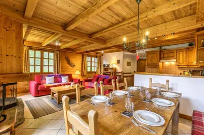 a kitchen with wooden cabinets and a table with chairs at Chalets d'Henri 67 - Happy Rentals in Chamonix-Mont-Blanc