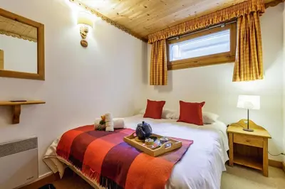 a bedroom with two beds and a window at Chalets d'Henri 67 - Happy Rentals in Chamonix-Mont-Blanc