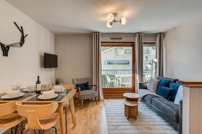a living room with a couch and a table at Apartment Fermes du Montenvers B11 - Alpes Travel - Central Chamonix - sleeps 4 in Chamonix-Mont-Blanc