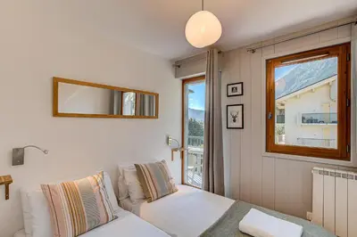 a living room with a couch and a window at Apartment Fermes du Montenvers B11 - Alpes Travel - Central Chamonix - sleeps 4 in Chamonix-Mont-Blanc