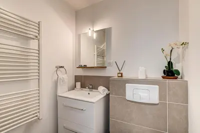 a white bathroom with a sink and a mirror at Apartment Fermes du Montenvers B11 - Alpes Travel - Central Chamonix - sleeps 4 in Chamonix-Mont-Blanc