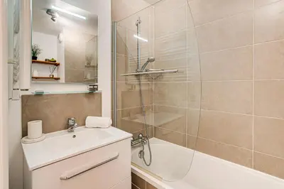 a bathroom with a tub and a sink and a shower at Apartment Fermes du Montenvers B11 - Alpes Travel - Central Chamonix - sleeps 4 in Chamonix-Mont-Blanc