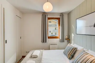a bedroom with a bed and a window at Apartment Fermes du Montenvers B11 - Alpes Travel - Central Chamonix - sleeps 4 in Chamonix-Mont-Blanc