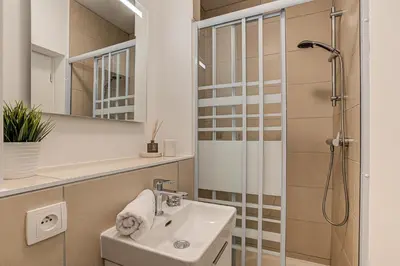 a bathroom with a sink and a shower at Apartment La Roseraie - Alpes Travel - Central Chamonix (sleeps 2-3) in Chamonix-Mont-Blanc