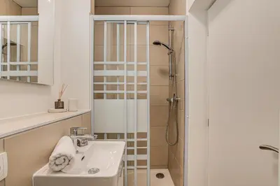 a bathroom with a sink and a shower at Apartment La Roseraie - Alpes Travel - Central Chamonix (sleeps 2-3) in Chamonix-Mont-Blanc