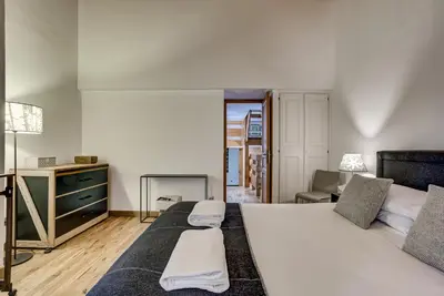 a bedroom with two beds and a desk and a chair at Pic Janvier - Alpes Travel - Les Praz (sleeps 4-6) in Chamonix-Mont-Blanc