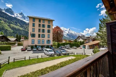 a view from a balcony of a building with a parking lot at Pic Janvier - Alpes Travel - Les Praz (sleeps 4-6) in Chamonix-Mont-Blanc