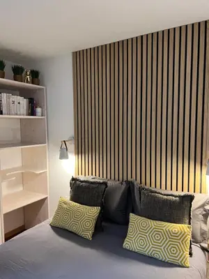 a bedroom with a bed with a large wooden headboard at Mont Blanc 25, vue Mont blanc, balcon, parking in Chamonix-Mont-Blanc