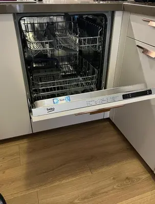a dishwasher with dishes in it in a kitchen at Mont Blanc 25, vue Mont blanc, balcon, parking in Chamonix-Mont-Blanc