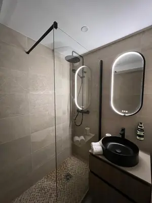 a bathroom with a black sink and a mirror at Mont Blanc 25, vue Mont blanc, balcon, parking in Chamonix-Mont-Blanc