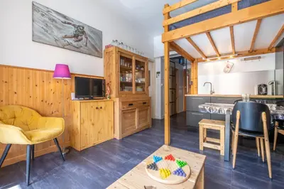 a living room with a couch and a table at Warm Haven in Chamonix With balcony in Chamonix-Mont-Blanc