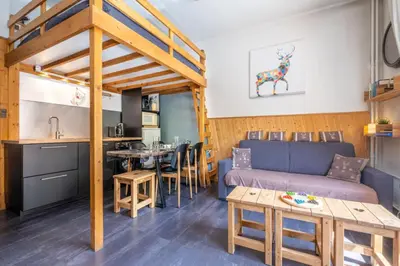 a kitchen and living room with a table and chairs at Warm Haven in Chamonix With balcony in Chamonix-Mont-Blanc