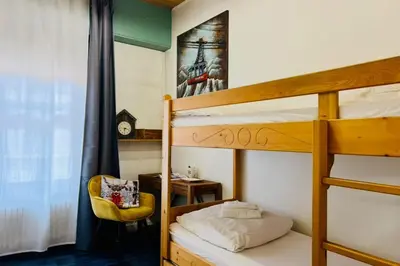 a bedroom with bunk beds with a desk and a chair at Warm Haven in Chamonix With balcony in Chamonix-Mont-Blanc
