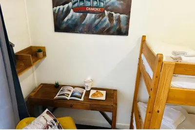 a room with a table with two bunk beds at Warm Haven in Chamonix With balcony in Chamonix-Mont-Blanc