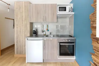 a small kitchen with a sink and a microwave at Les Dryades - Rénové - Balcon avec vue Mt Blanc in Les Houches