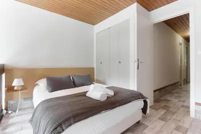 a bedroom with a bed and a wooden ceiling at Le Crêtet Mont-Blanc in Chamonix-Mont-Blanc