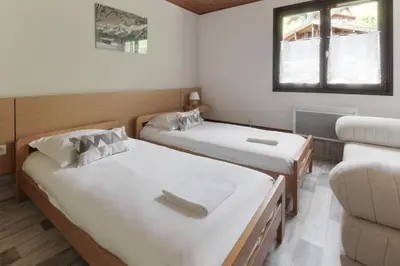 a room with two beds and a couch at Le Crêtet Mont-Blanc in Chamonix-Mont-Blanc