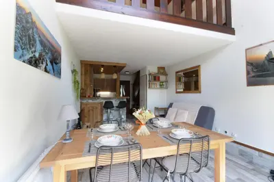 a dining room with a wooden table and chairs at Le Crêtet Mont-Blanc in Chamonix-Mont-Blanc