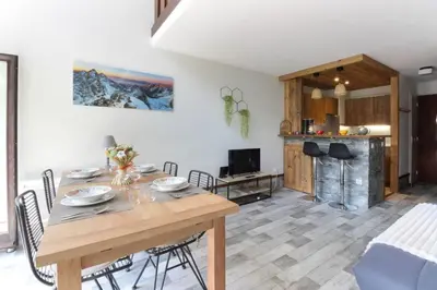 a dining room and living room with a table and chairs at Le Crêtet Mont-Blanc in Chamonix-Mont-Blanc