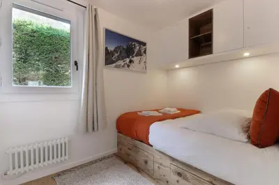 a bedroom with a bed and a window at Les Gaillands in Chamonix-Mont-Blanc