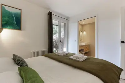 a bedroom with a large bed with a window at Les Gaillands in Chamonix-Mont-Blanc