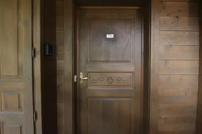 a wooden door with a sign on it next to two doors at Les Capucins - Calm - Mont-Blanc - Lake Gaillland in Chamonix-Mont-Blanc
