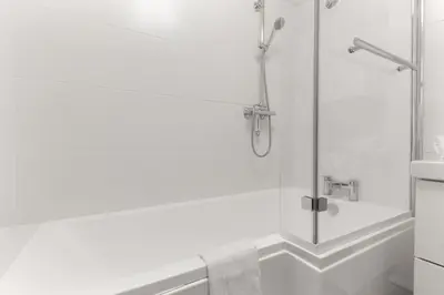 a bathroom with a shower with a glass door at Le Jardin de Champraz in Chamonix-Mont-Blanc