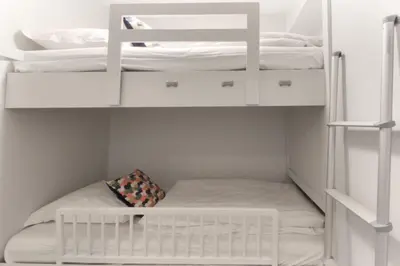 a small closet with white cabinets and white beds at Le Jardin de Champraz in Chamonix-Mont-Blanc