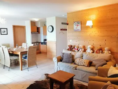 a living room with a couch with stuffed teddy bears on it at T4 à Morillon 1100 avec Wifi et Animaux acceptés - FR-1-815-79 in Morillon