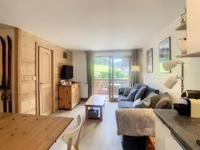 a living room with a couch and a table at Appartement 2 pièces + cabine à proximité du village et téléski, cuisine équipée - FR-1-560-89 in Combloux