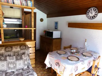 a dining room with a table and a clock on the wall at Résidence Mont'seu - Mont'seu C401 MAE-6354 in Les Contamines-Montjoie