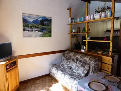 a living room with a couch and a television at Résidence Mont'seu - Mont'seu C401 MAE-6354 in Les Contamines-Montjoie