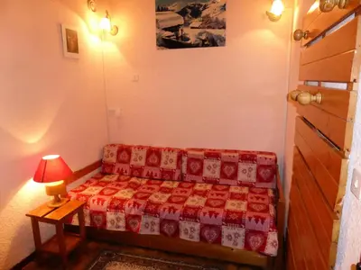 a bedroom with a couch and a table with a lamp at Résidence Mont'seu - Mont'seu C401 MAE-6354 in Les Contamines-Montjoie