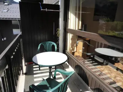 a patio with tables and chairs on a balcony at Résidence Mont'seu - Mont'seu C401 MAE-6354 in Les Contamines-Montjoie