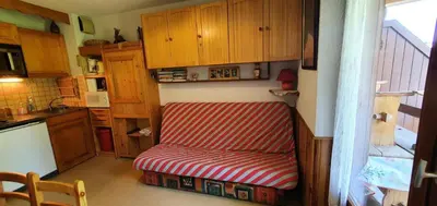 a red and white chair in a small kitchen at Résidence Ecrin Des Glaciers Daim - Ecrin des Glaciers D41 MAE-6334 in Combloux