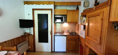 a kitchen with wooden cabinets and a white refrigerator at Résidence Ecrin Des Glaciers Daim - Ecrin des Glaciers D41 MAE-6334 in Combloux