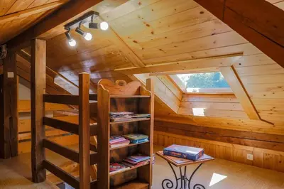 a attic room with a bunk bed in a cabin at Appartement l'éterlou in Sallanches