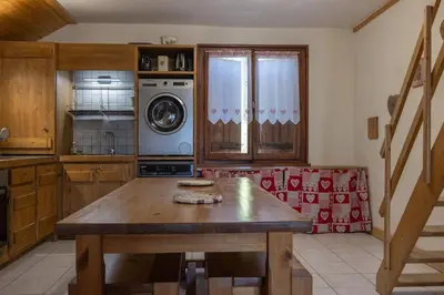 a kitchen with a wooden table in a room at Appartement l'éterlou in Sallanches