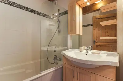 a bedroom with a large bed and a wooden table at Chateau - Charming Apartment in the city Center with 3 bedrooms - By Cozee Rentals in Saint-Gervais-les-Bains